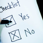 Image of a pen hovering over two boxes marked yes and no, with a tick and a cross in each