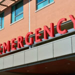 image of red letters spelling 'emergency' above a hospital entrance